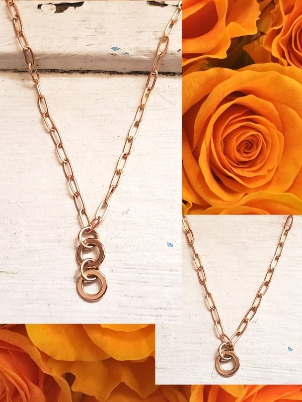 2 bronze tribe necklaces on wood